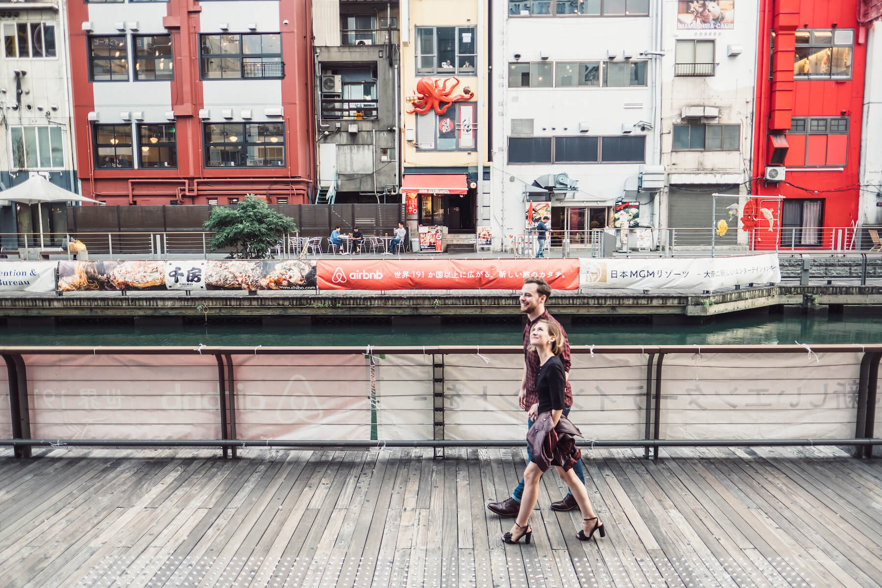 couple walking and looking at the colorful buildings in Osaka, Japan
