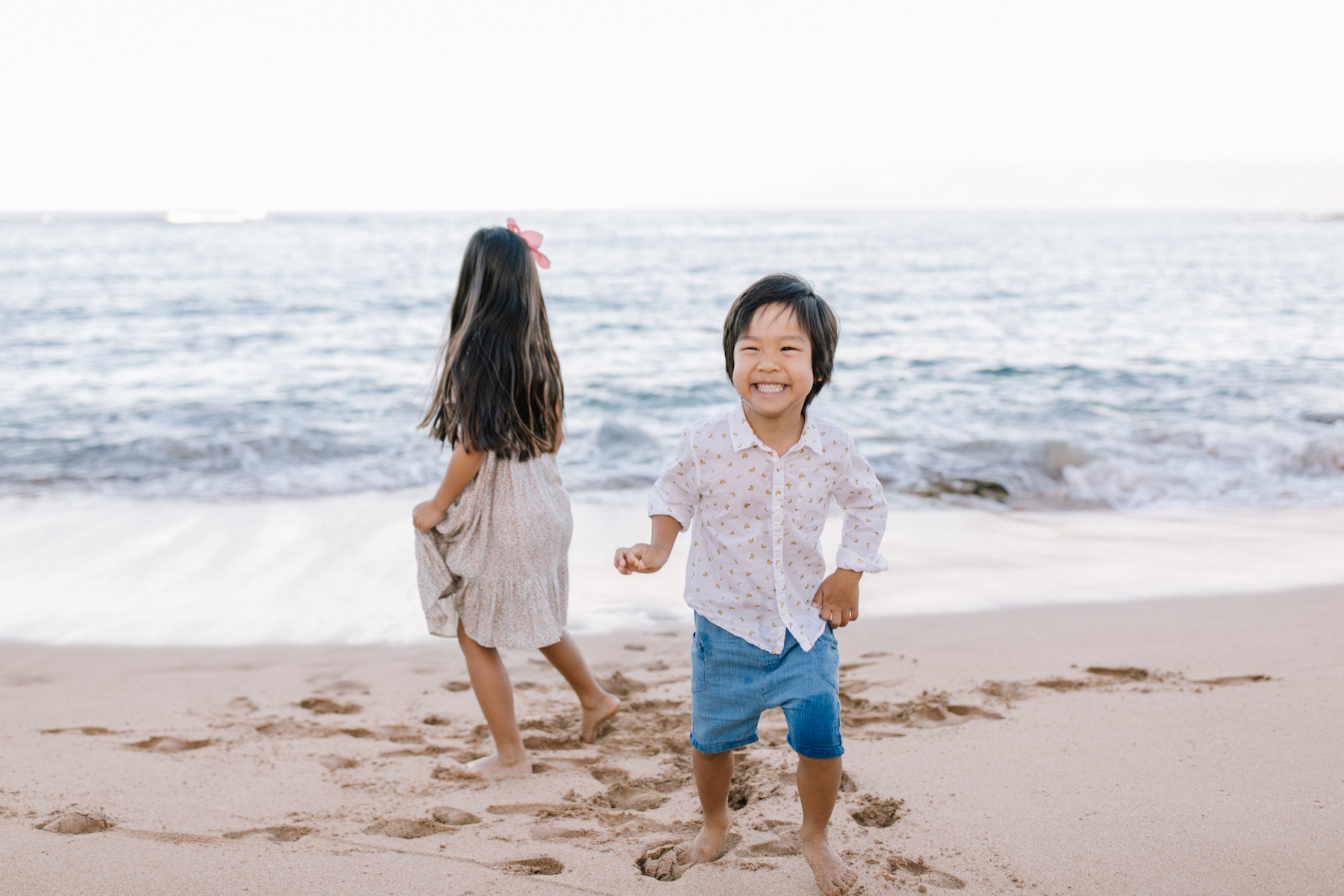small children, a brother and sister having fun on the beach in Maui, Hawaii