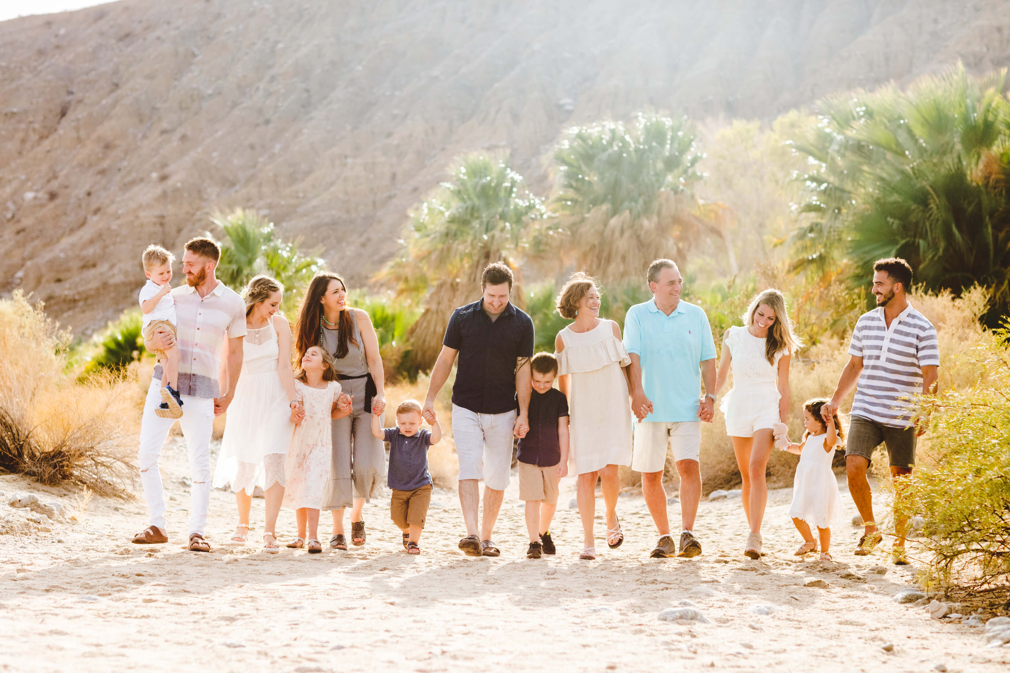 Large family walking together in a desert area on a sunny day