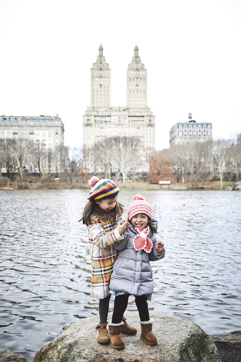 two sisters hugging each other in central park New York City, New York