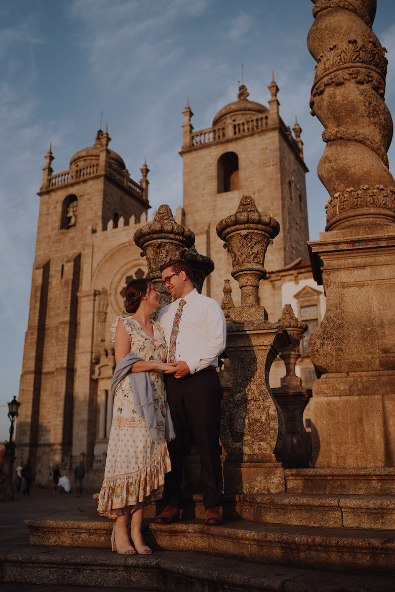 couple standing in a courtyard in Porto, Portugal