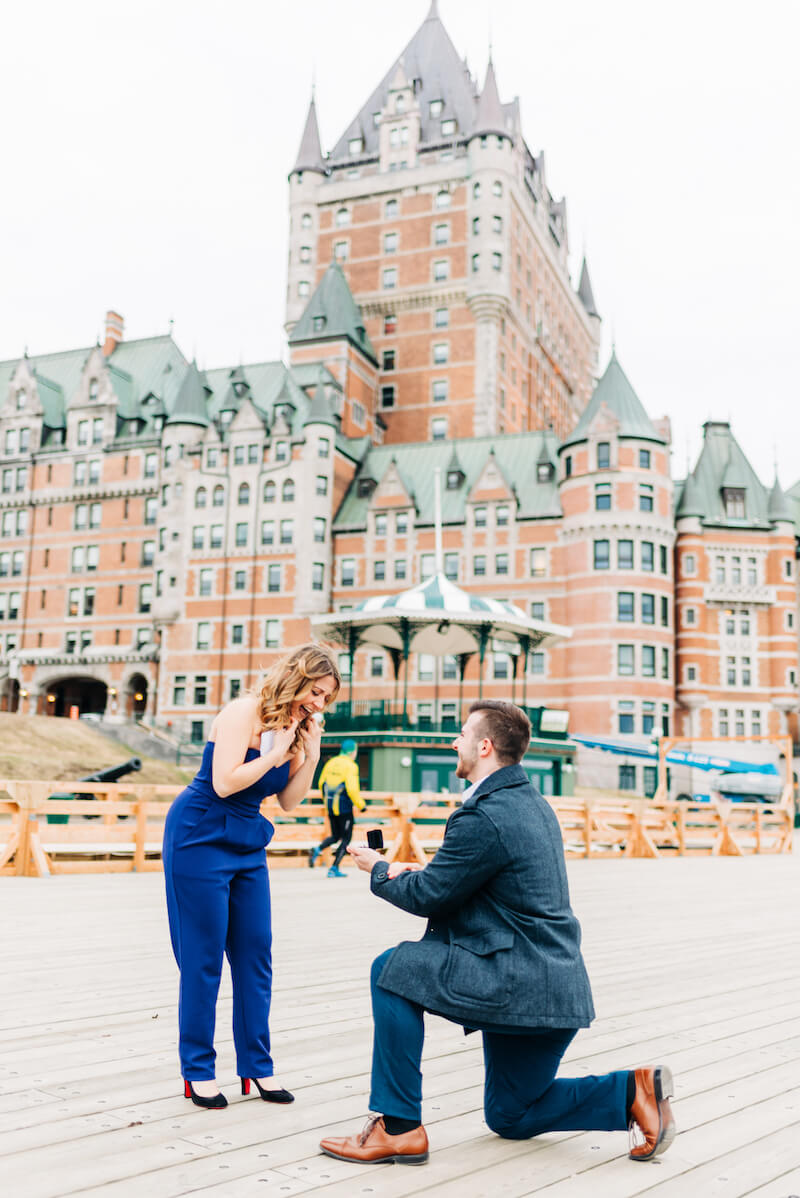 a man is on one knee proposing to a woman in Quebec City, Canada