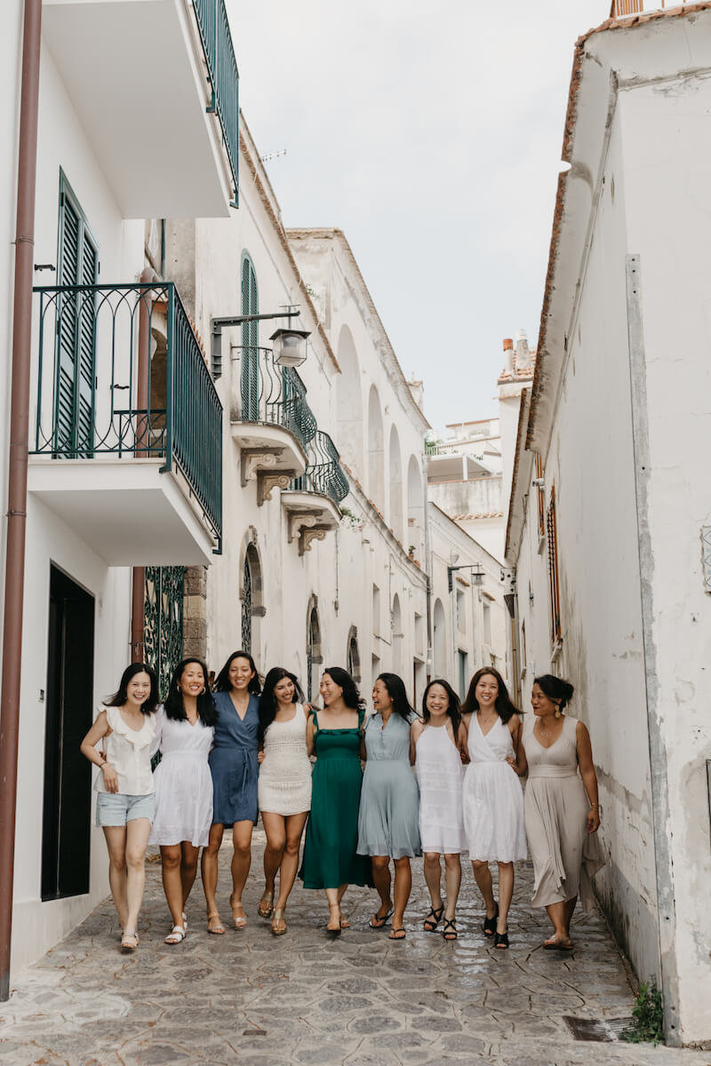  a large group of friends on a girls trip to Amalfi Coast walking through the town of Ravello, Italy