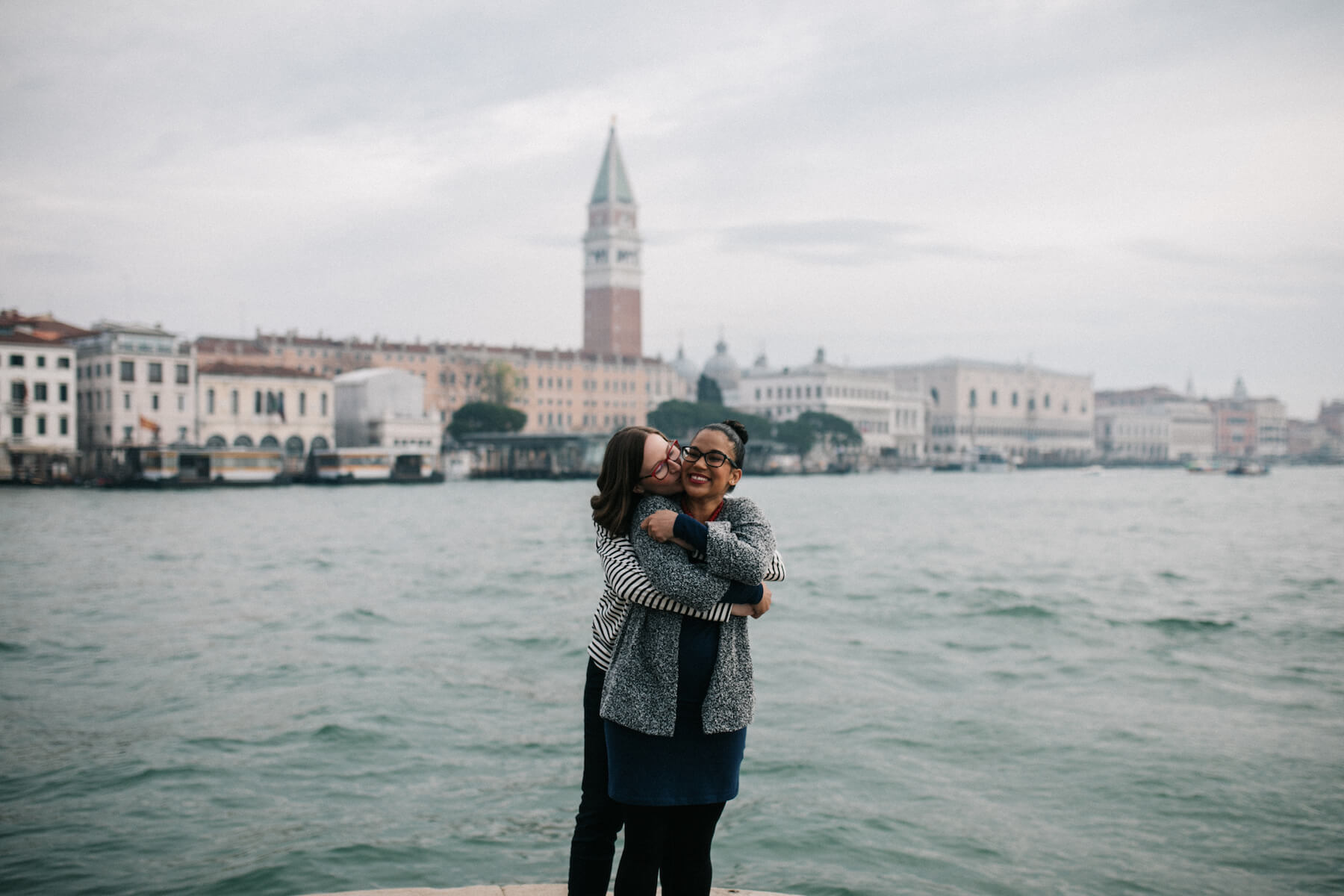 LGBTQ pregnant couple embracing each other in Venice, Italy