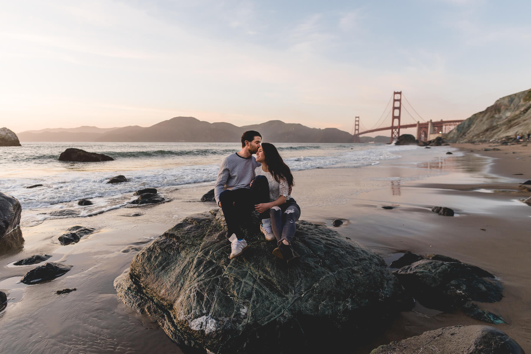 Couple in San Francisco walking with Golden Gate Bridge