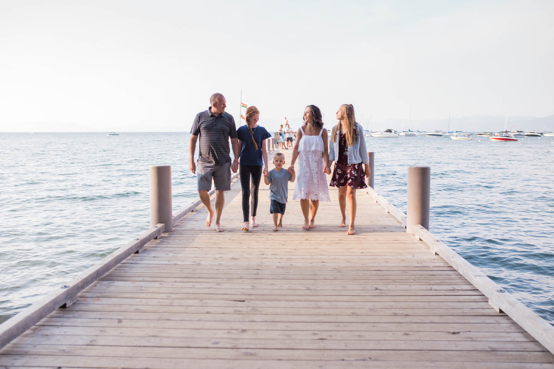 Family of 5 walking on a dock in Lake Tahoe United States USA