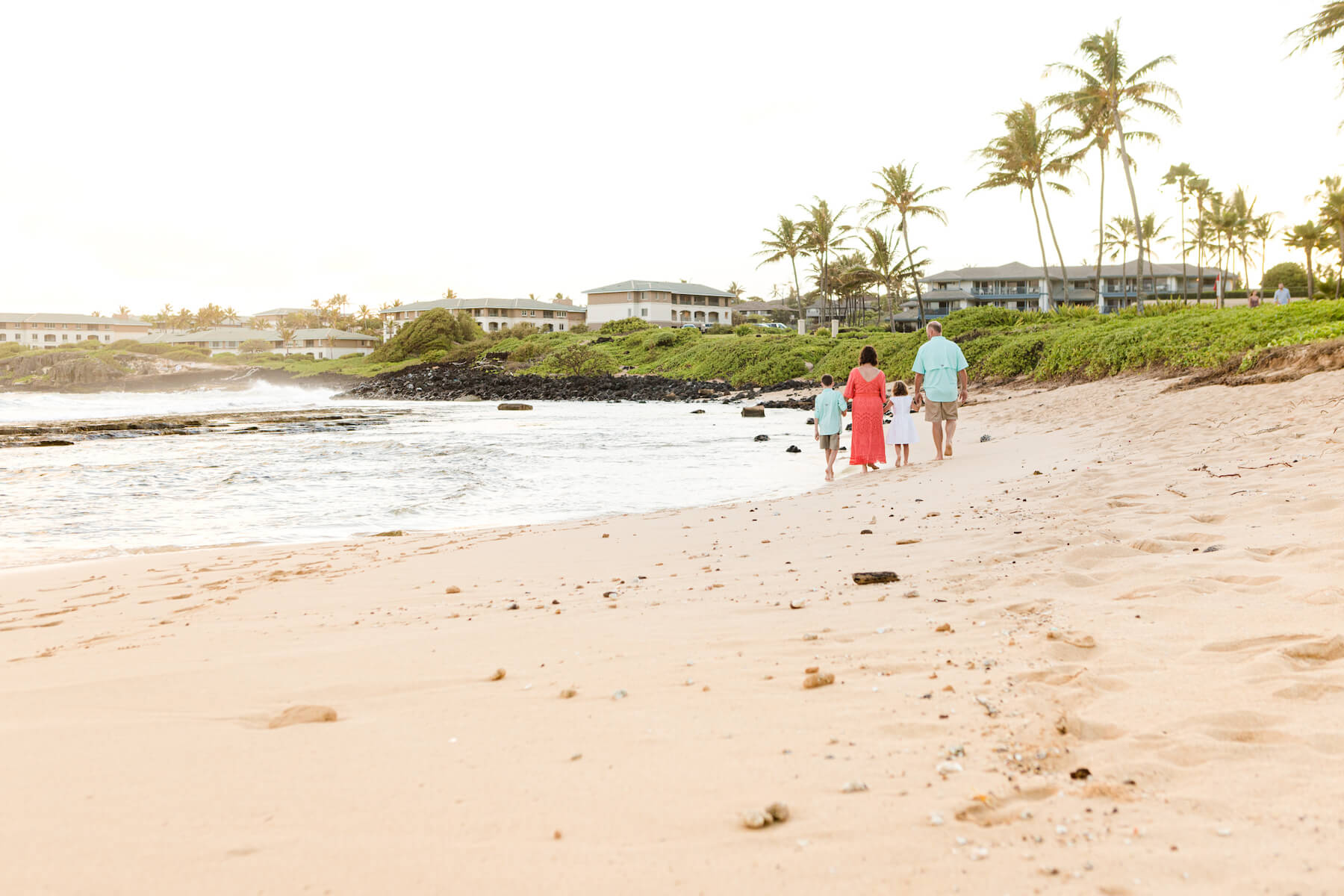 Family walking on the beach in Kauai Hawaii USA