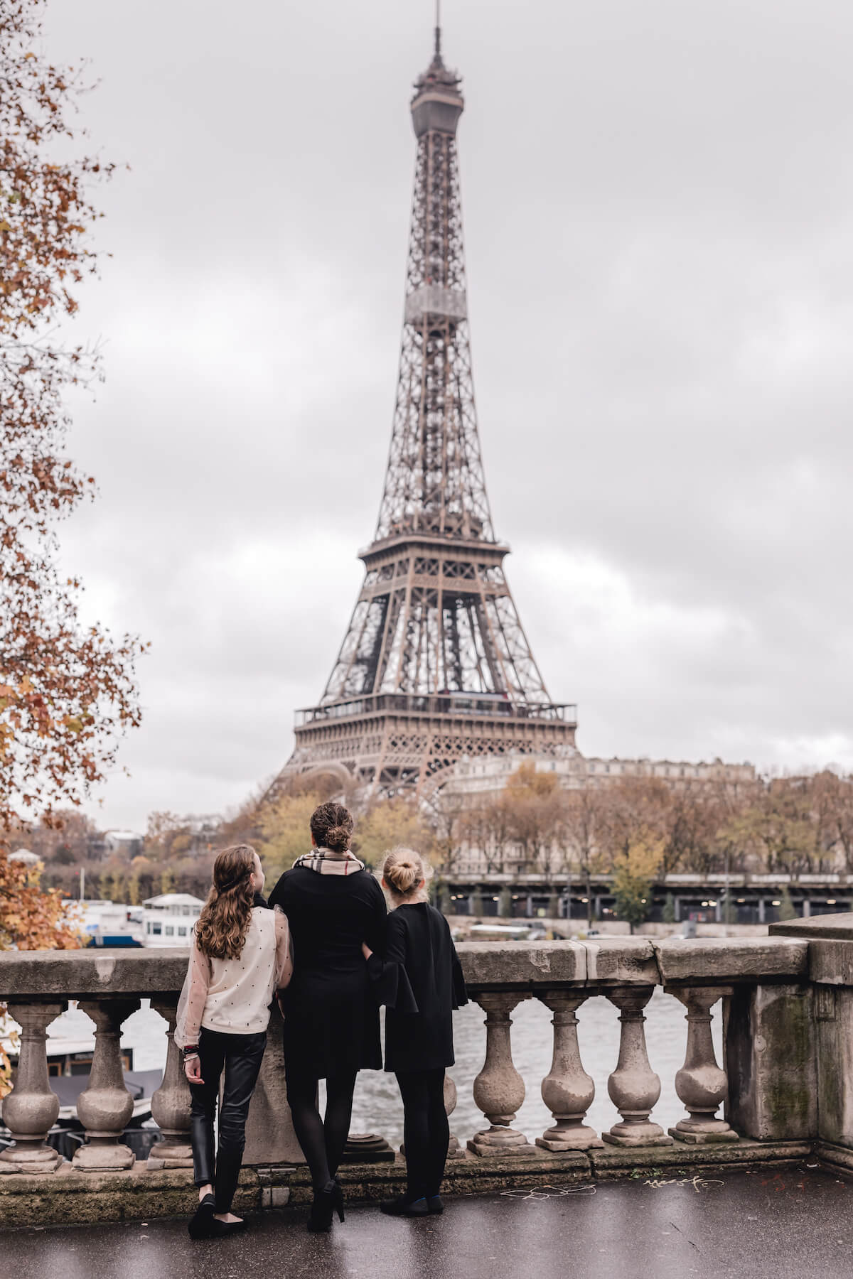 Mom and daughters in Paris France in front of the Eiffel Tower