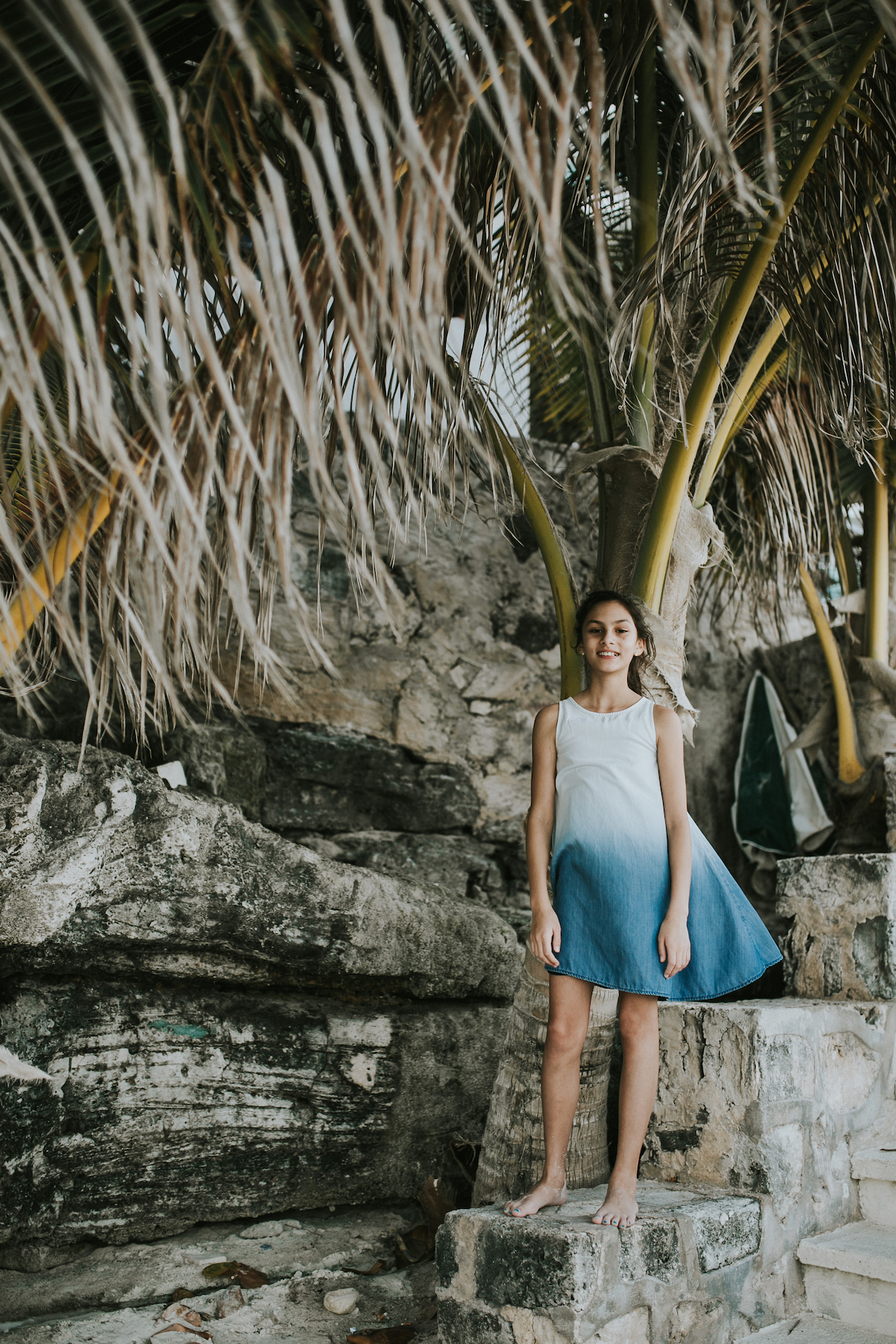 Girl by a palm tree in Cancun Mexico