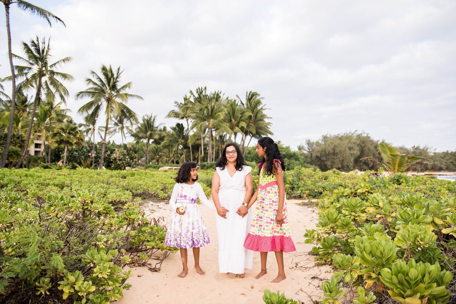 Mother and daughters on a beach in Kauai Hawaii