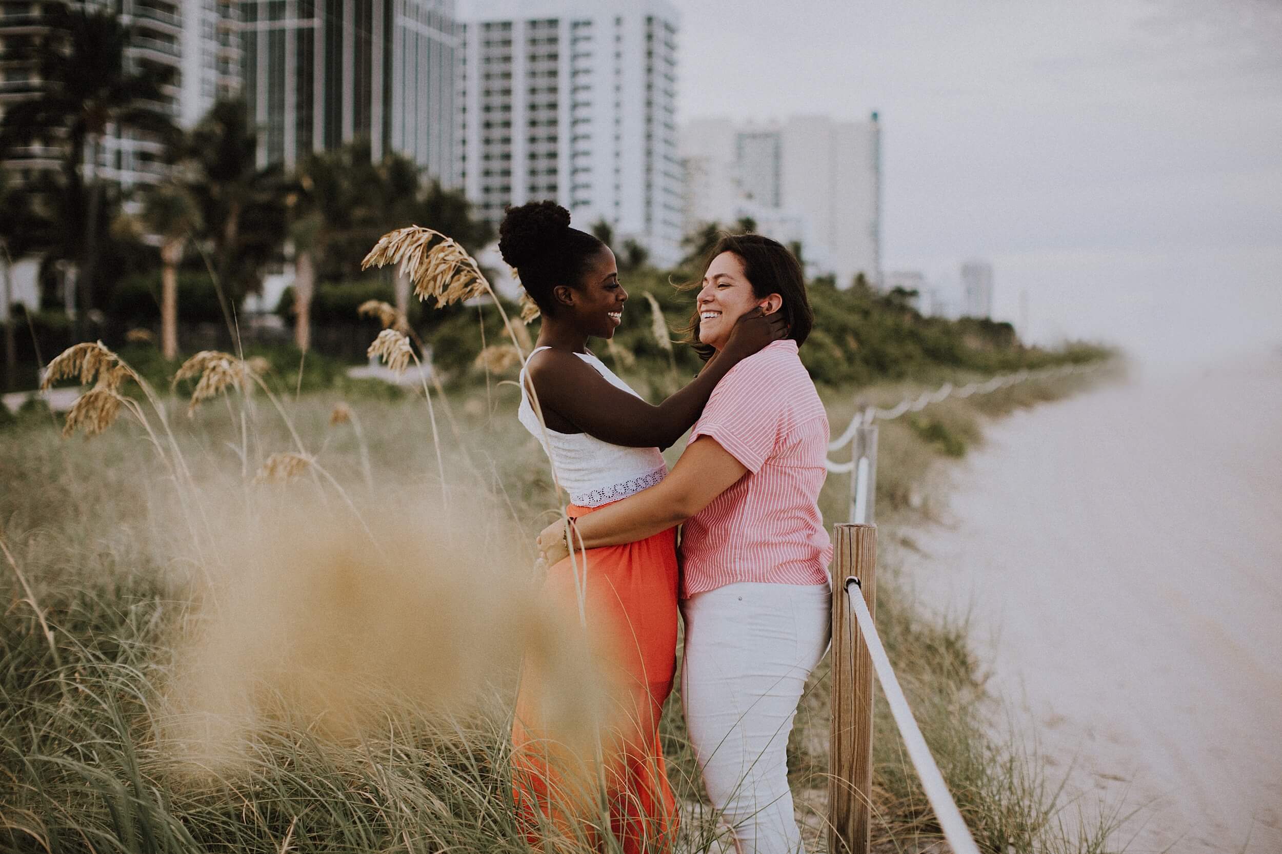 A Lesbian couple embrace on the beach in Miami, USA.