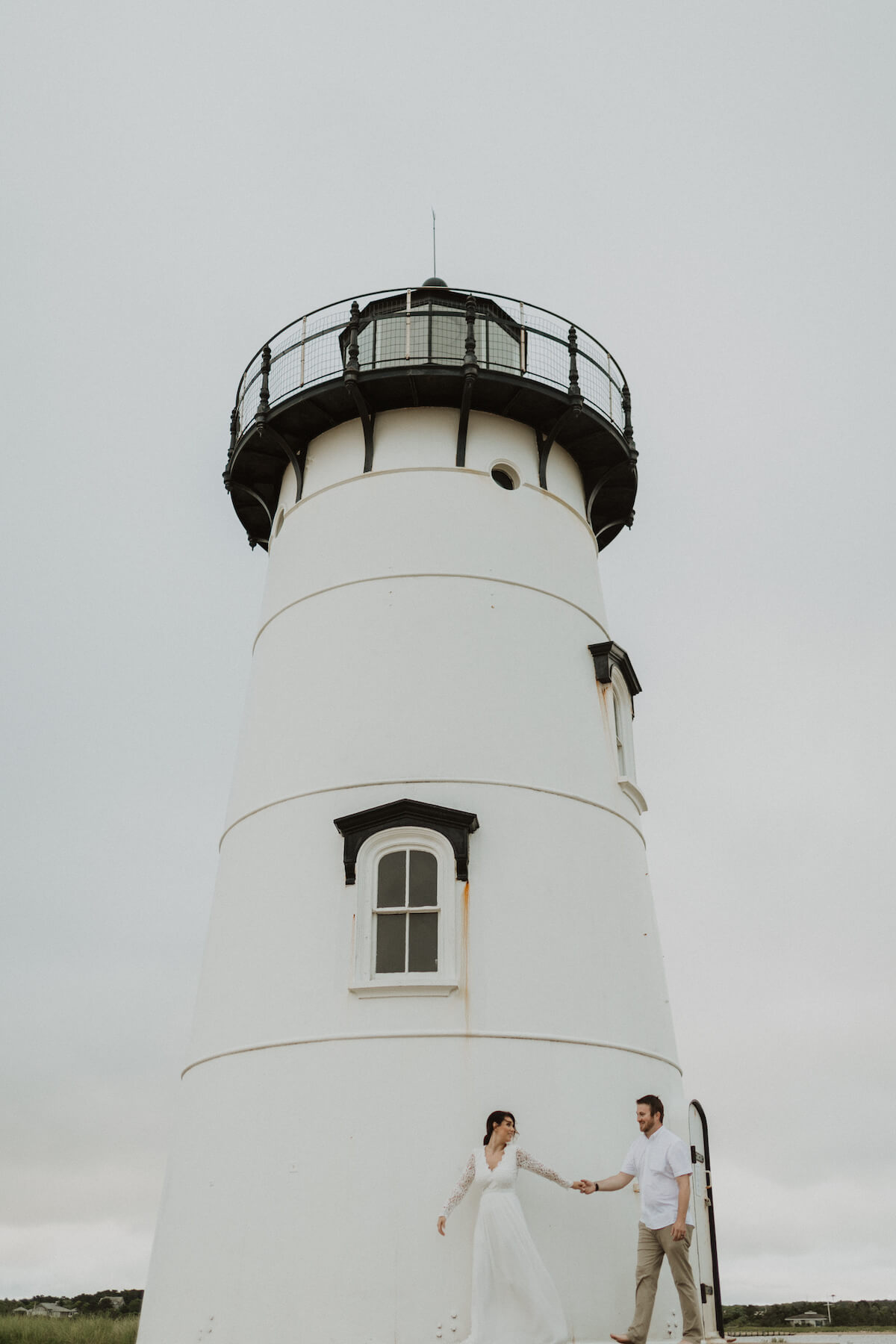 A couple walks along a dock in Martha's Vineyard, Massachusetts, USA.