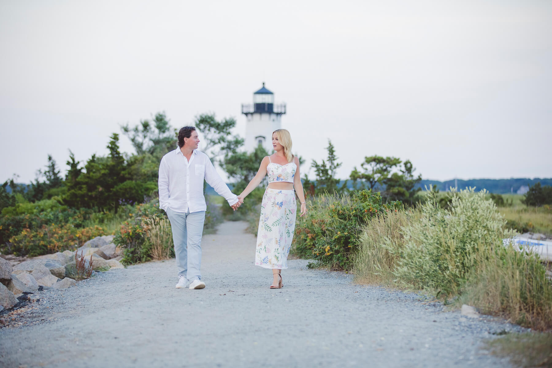 A couple walks along a dock in Martha's Vineyard, Massachusetts, USA.