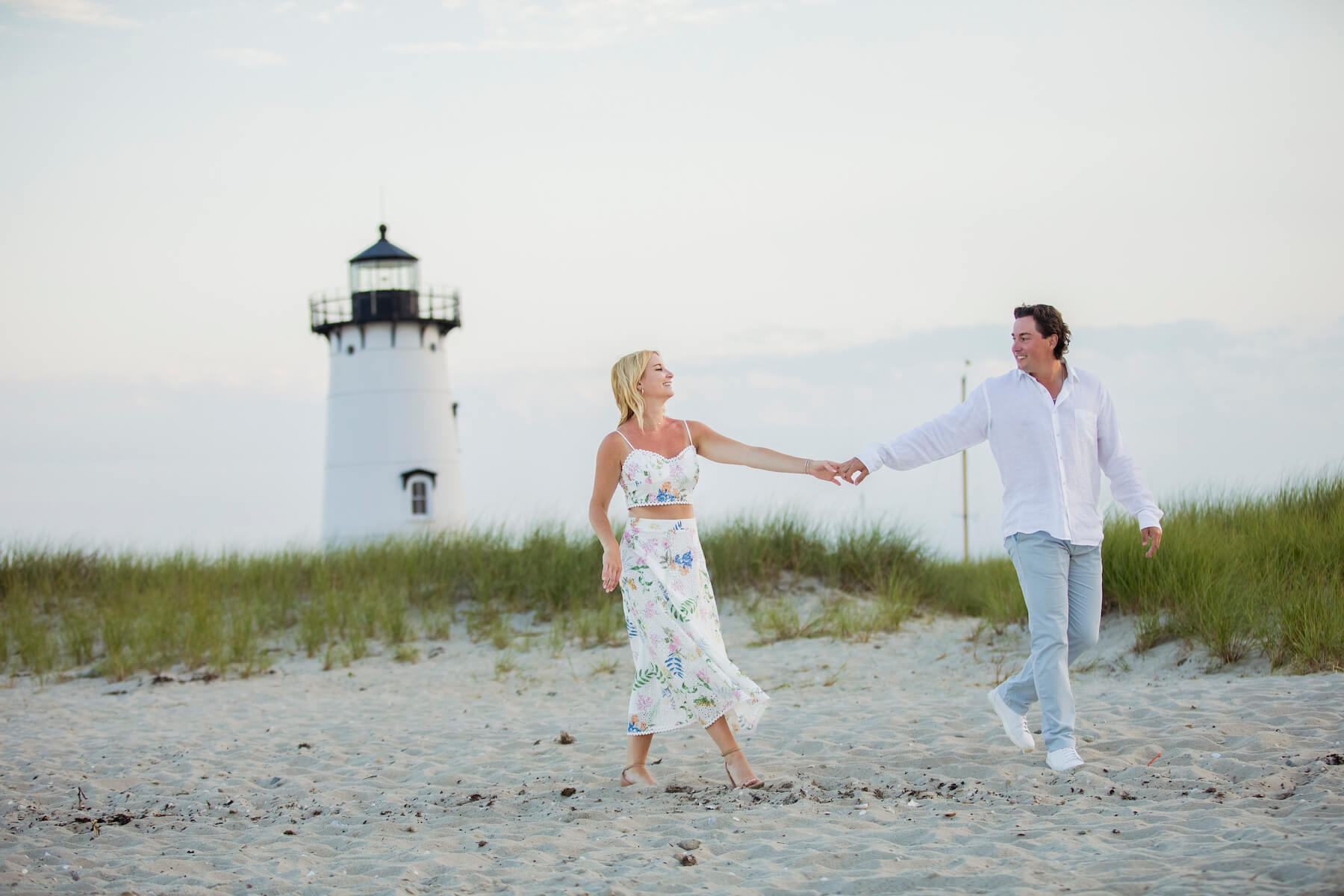 A couple walks along a dock in Martha's Vineyard, Massachusetts, USA.