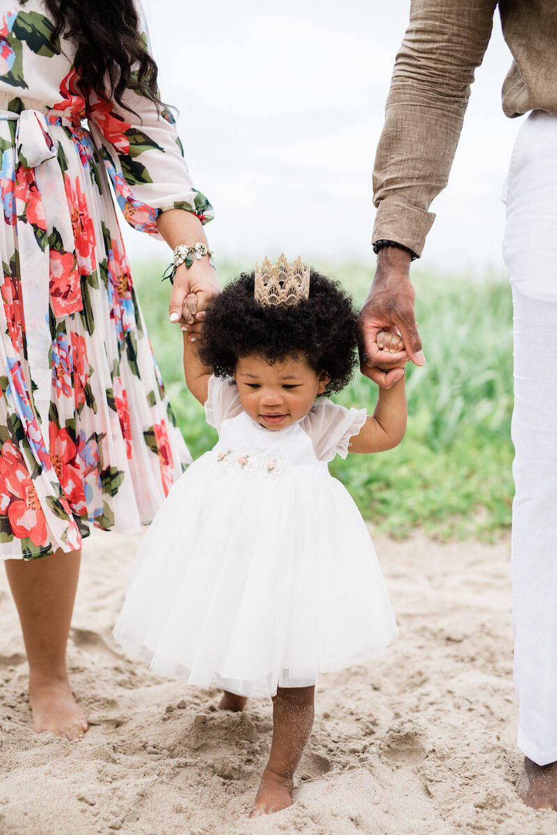 Family of 3 walking down the beach in Ft. Lauderdale, Florida