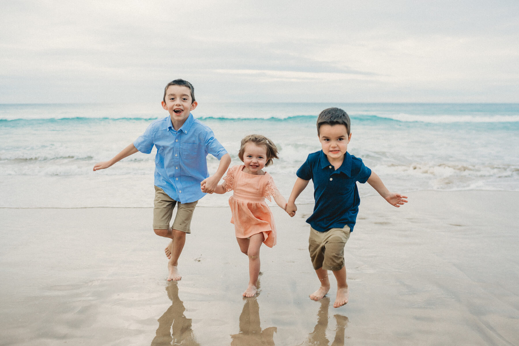 Kids running on the beach in Kona, Hawaii