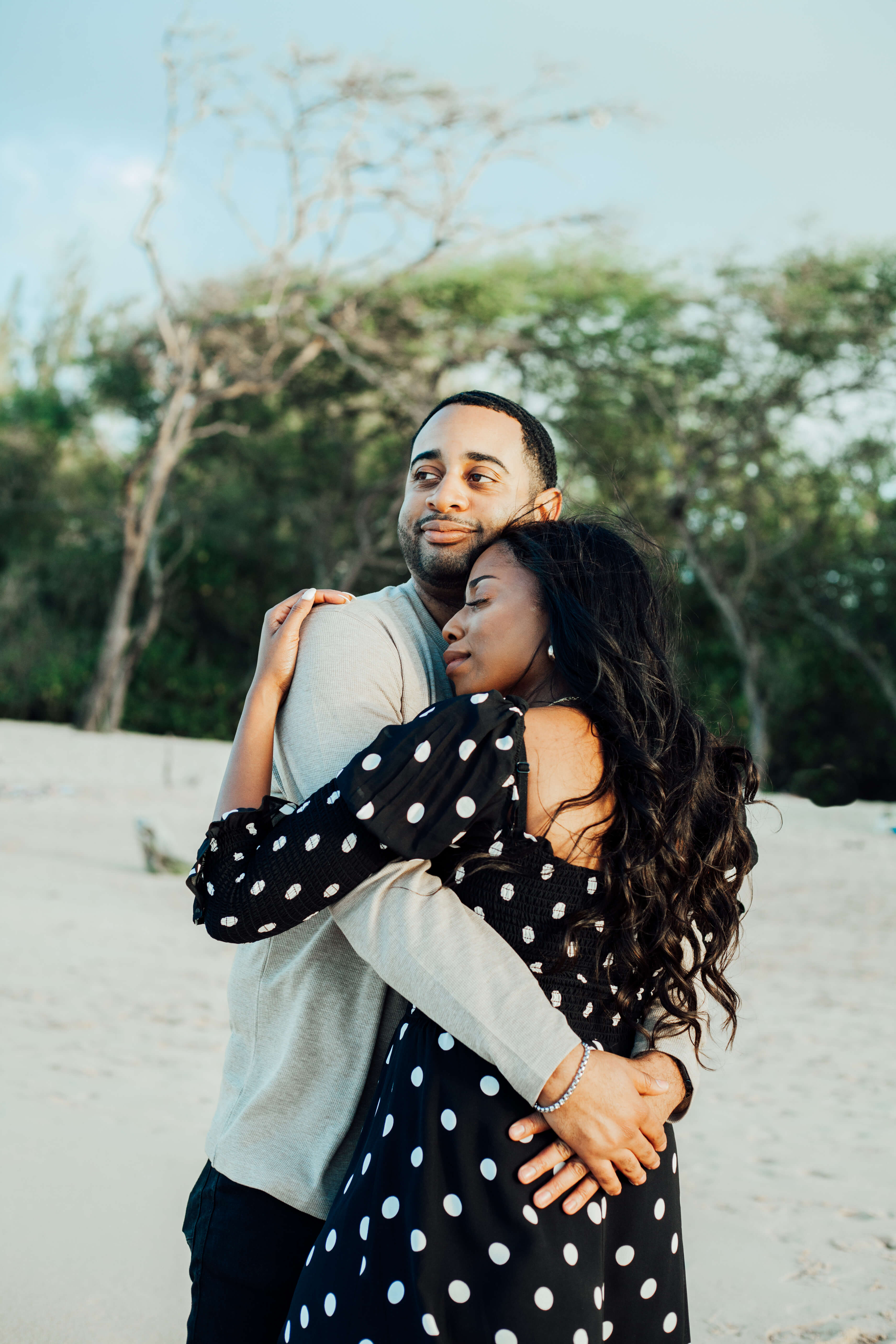 Family of 3 walking down the beach in Ft. Lauderdale, Florida
