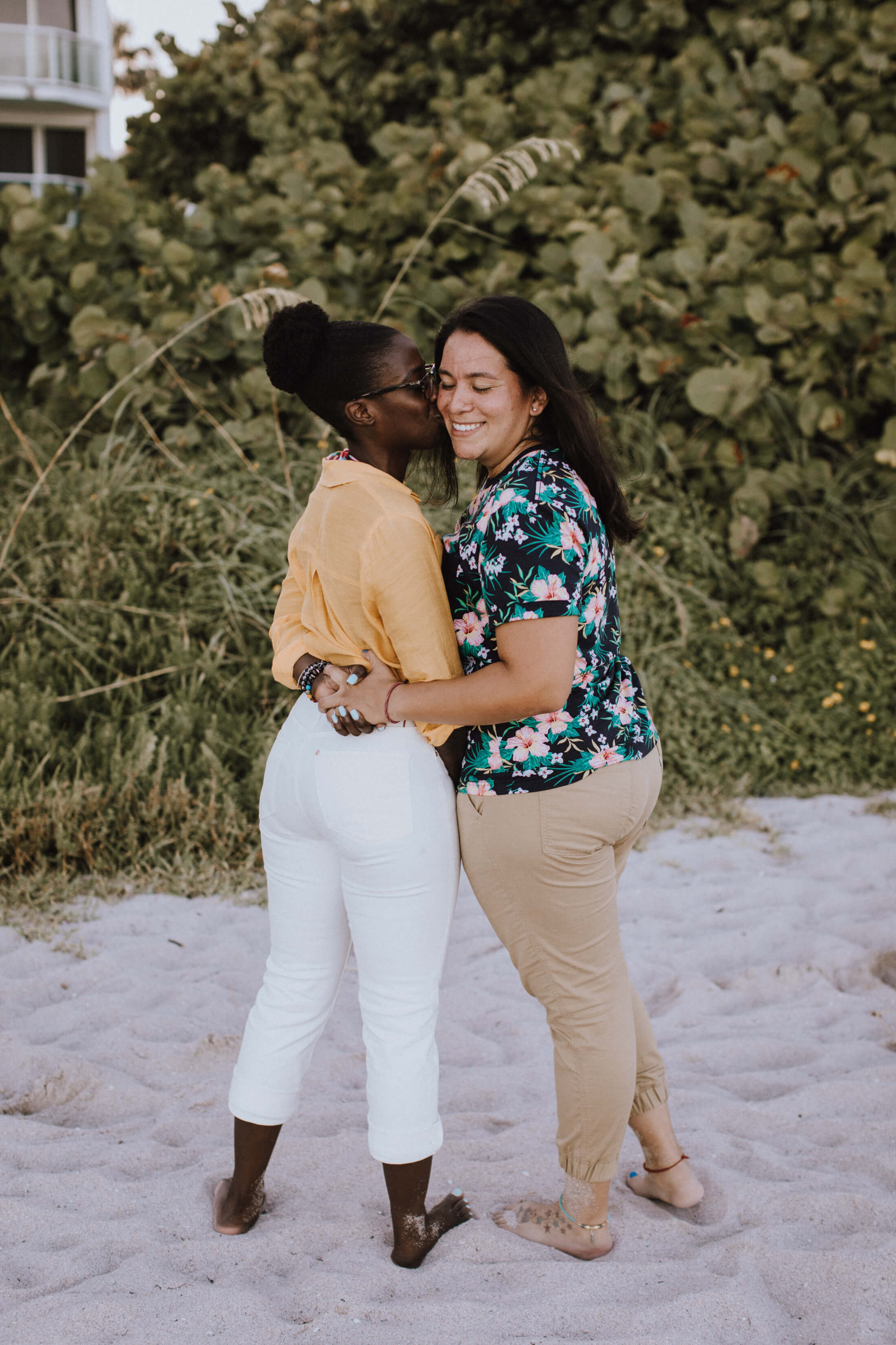 LGBTQ couple sitting on the beach in Miami, Florida