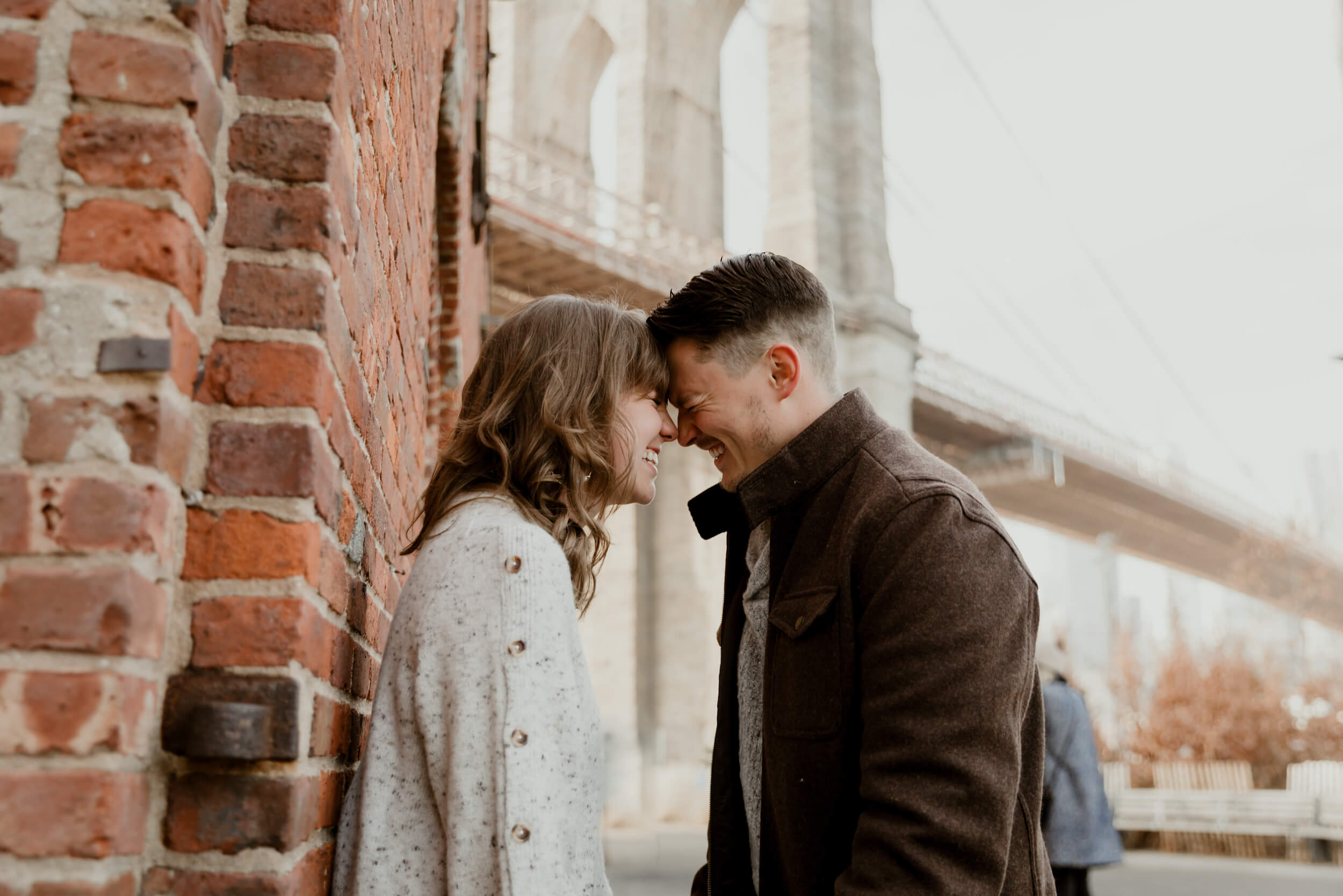 Couple holding hands walking in DUMBO, NYC