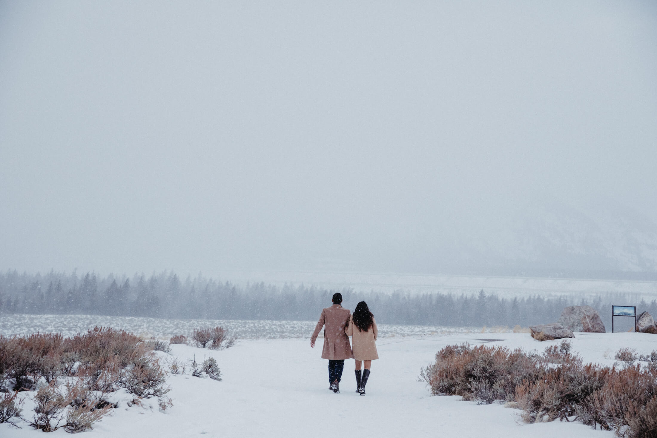 Couple walking in the snow in Jackson Hole, Wyoming