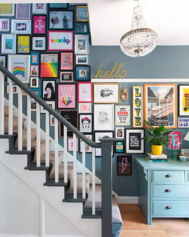 Gallery wall in a colourful stairwell.