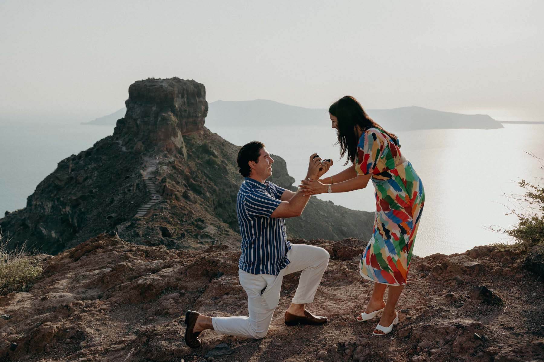 Woman wearing a red dress is being proposed to on a doc in Mauritius