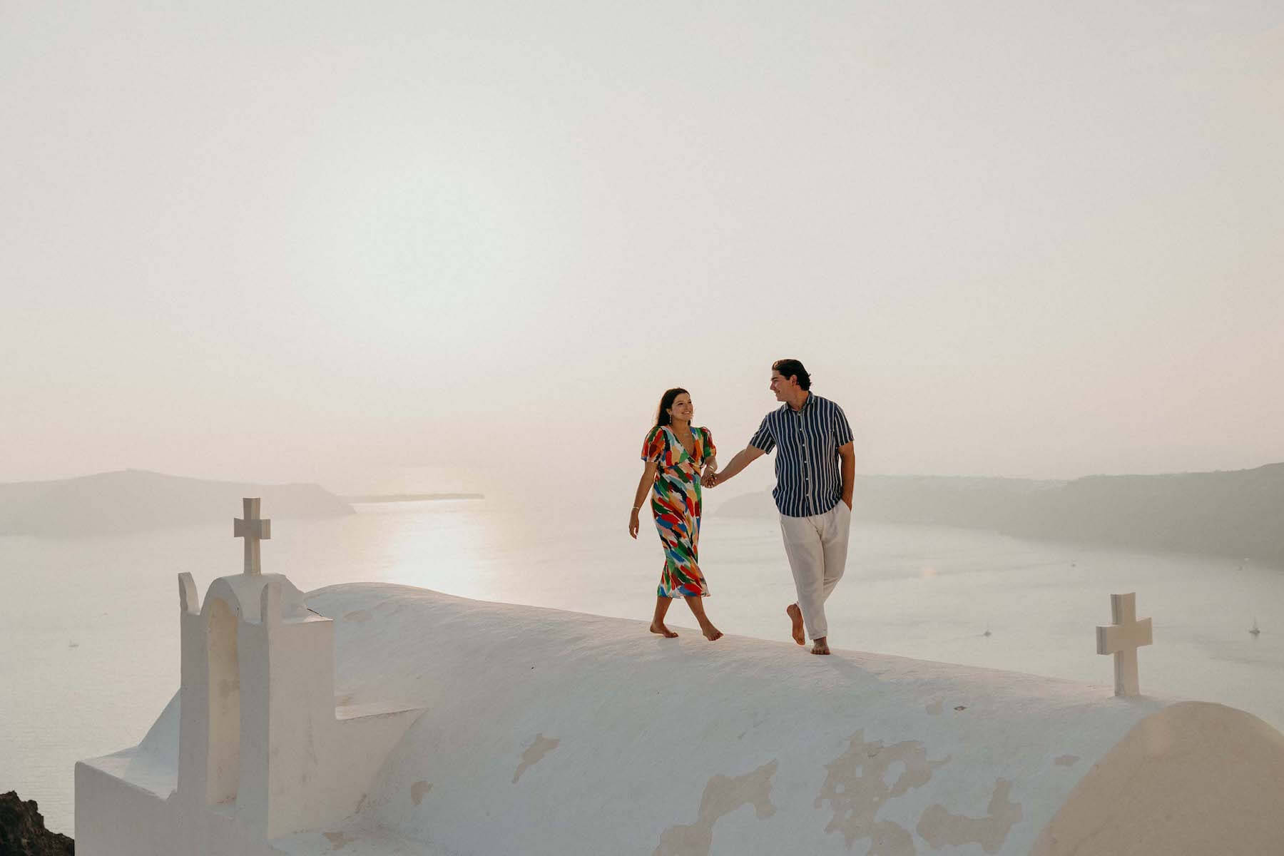 Woman wearing a red dress is being proposed to on a doc in Mauritius