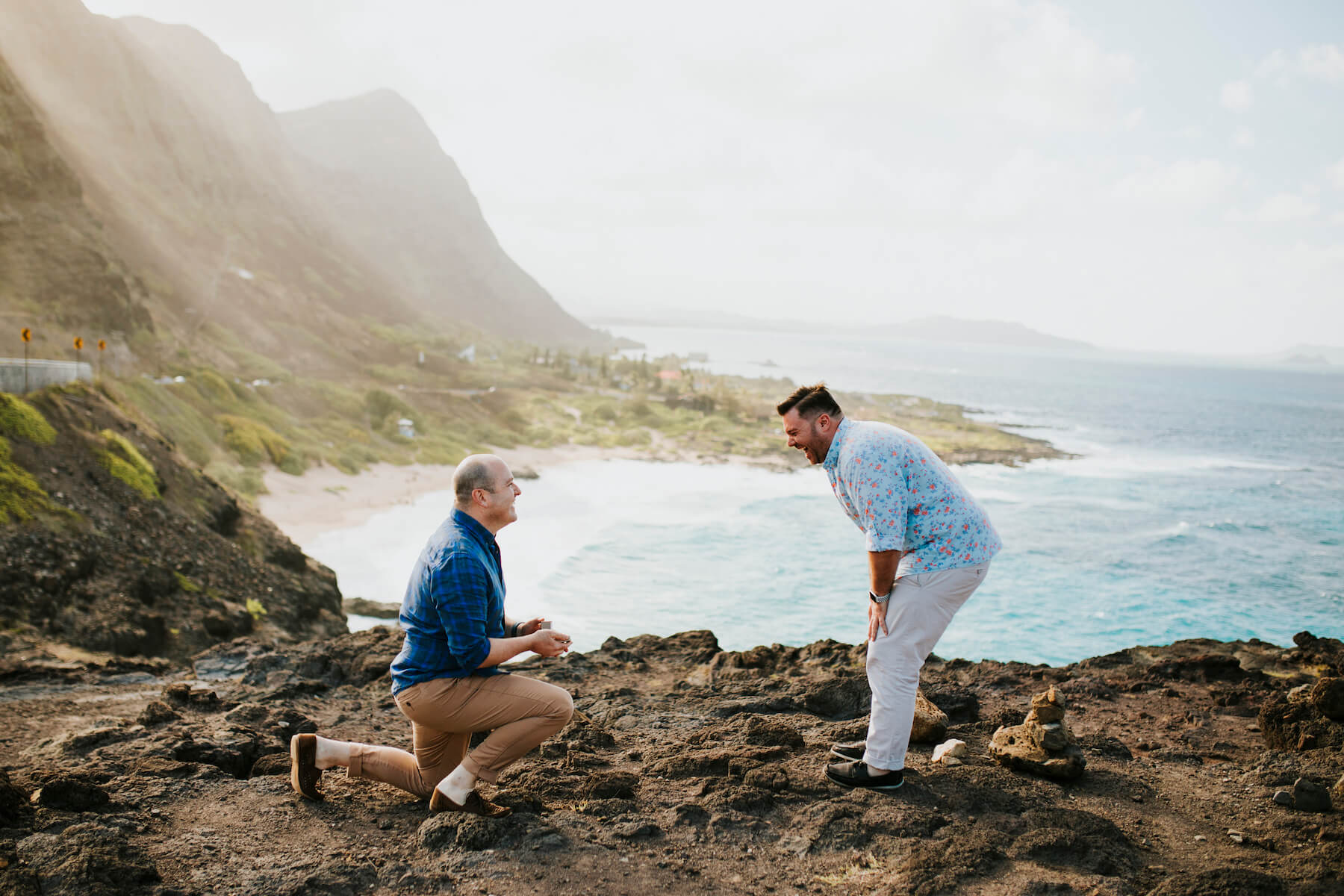 Woman wearing a red dress is being proposed to on a doc in Mauritius