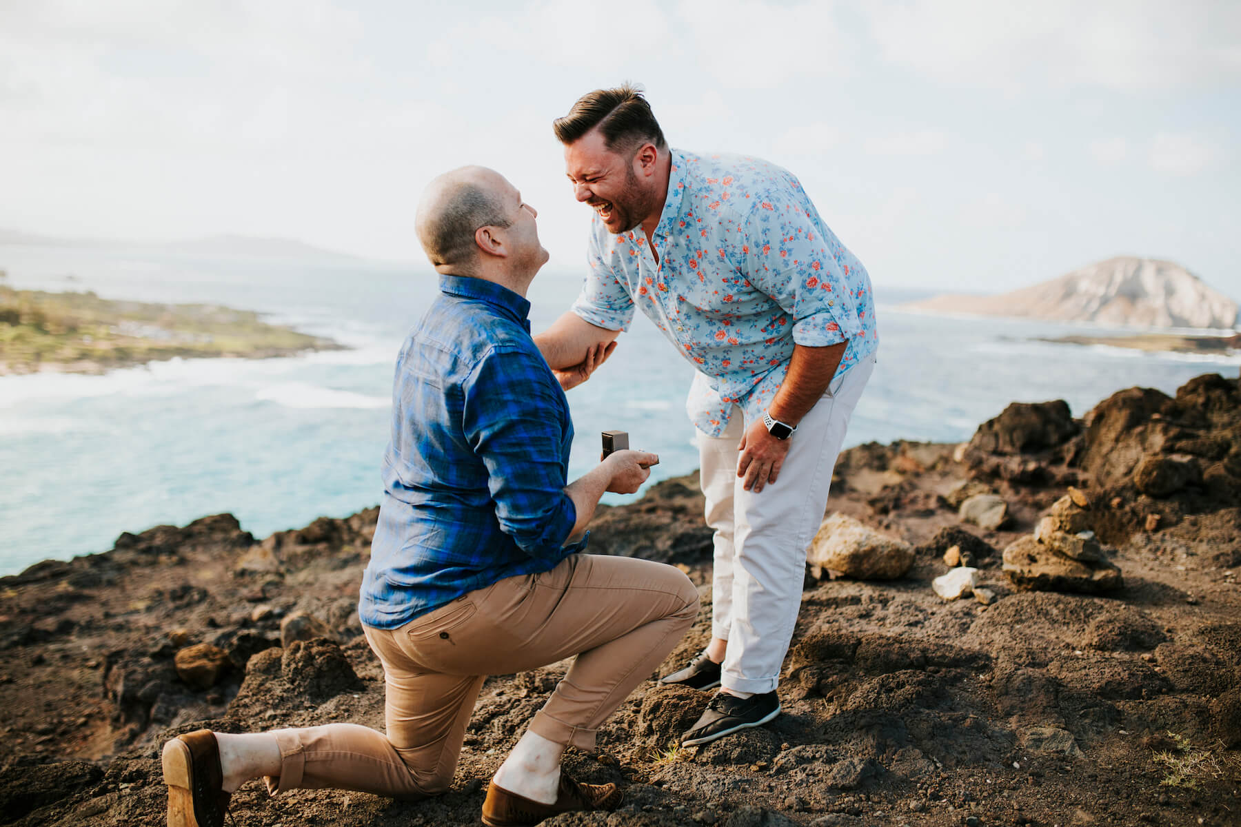 Woman wearing a red dress is being proposed to on a doc in Mauritius