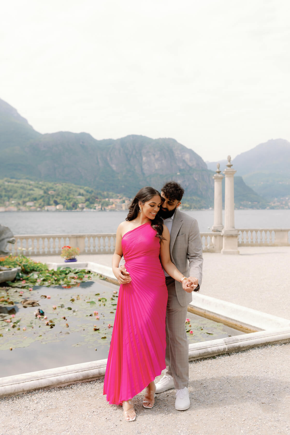 Woman wearing a red dress is being proposed to on a doc in Mauritius