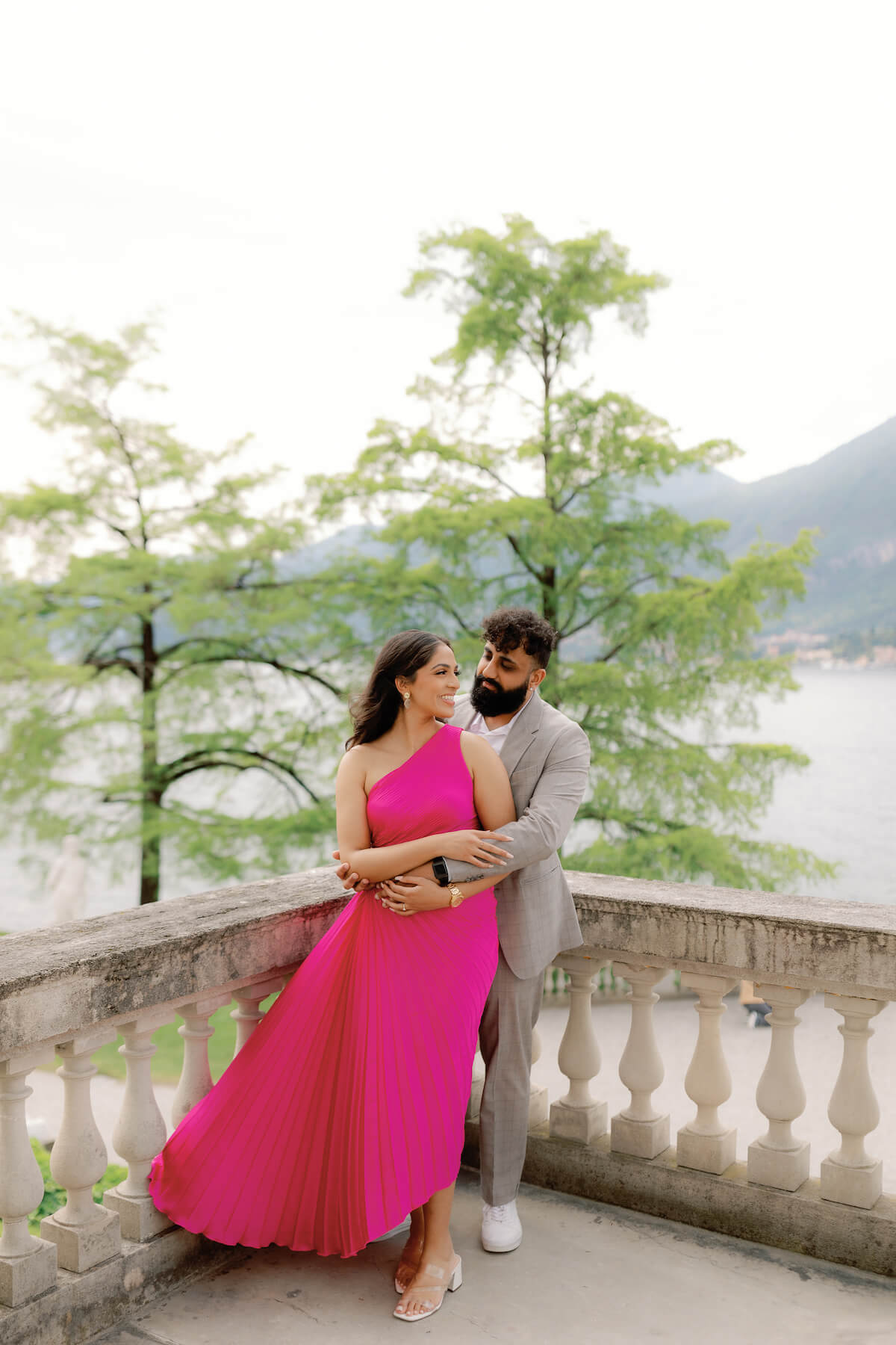 Woman wearing a red dress is being proposed to on a doc in Mauritius