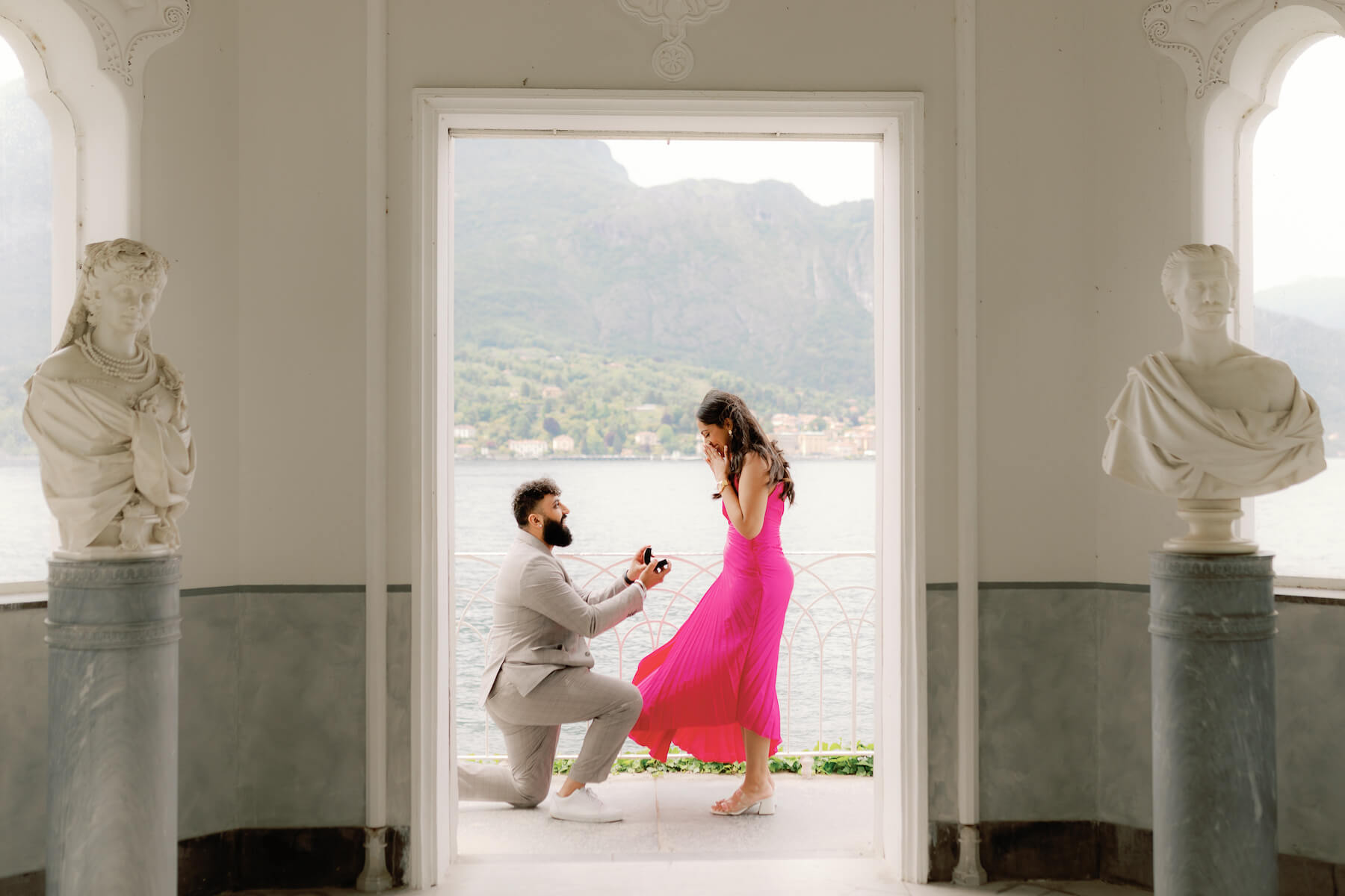 Woman wearing a red dress is being proposed to on a doc in Mauritius