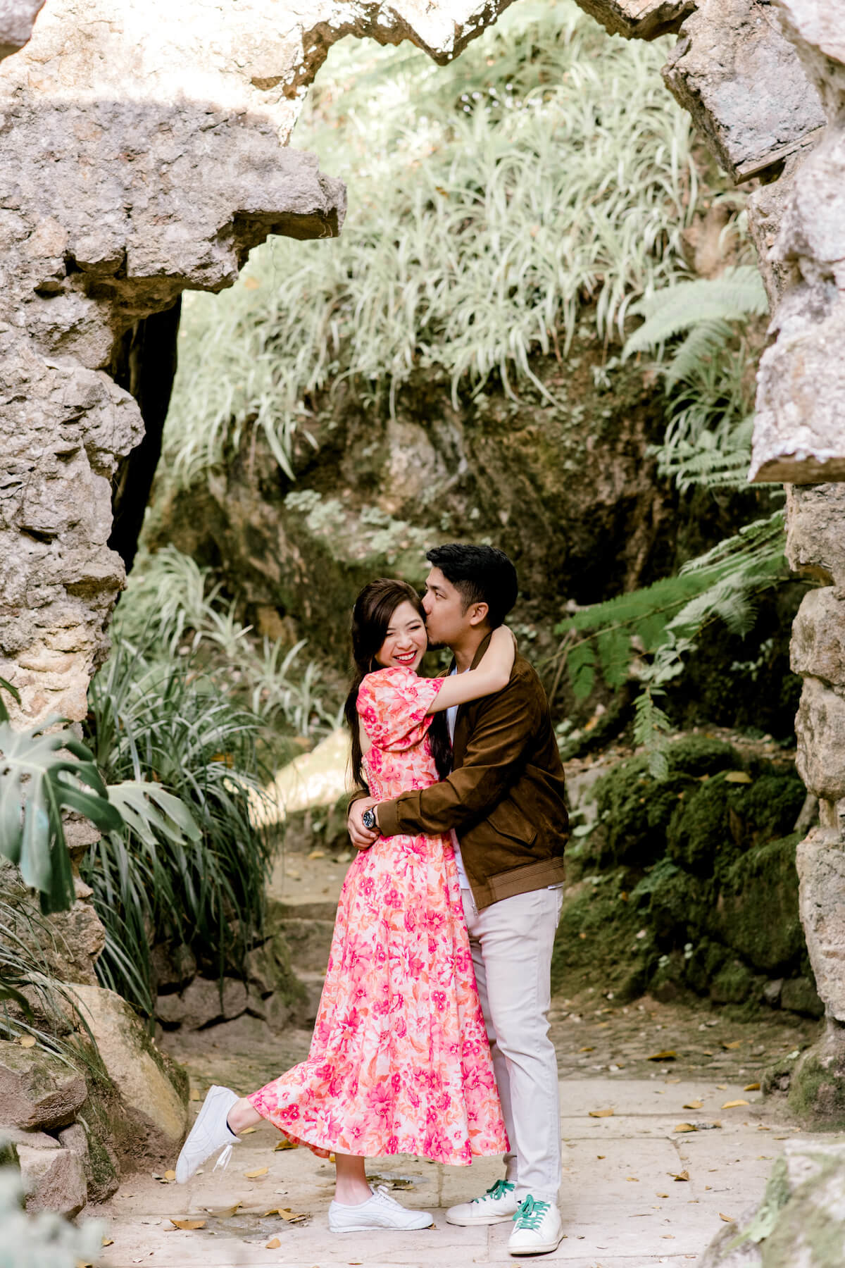 Woman wearing a red dress is being proposed to on a doc in Mauritius