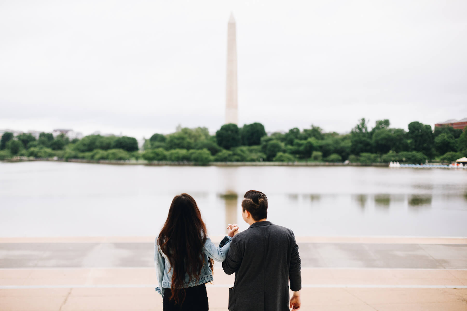 Couple on the steps of the Lincoln Memorial with the Washington Monument in the background in Washington DC on a couple photoshoot with Flytographer.
