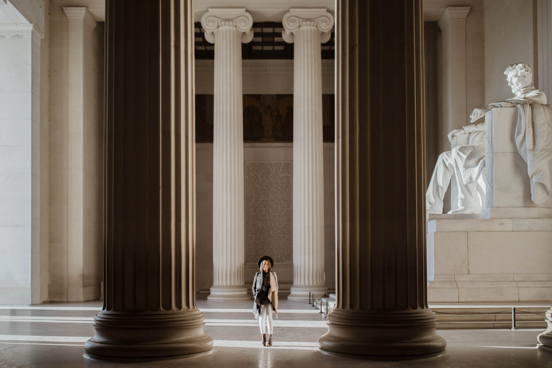 Woman walking at the Lincoln Memorial in Washington DC on a modern headshot photoshoot with Flytographer.