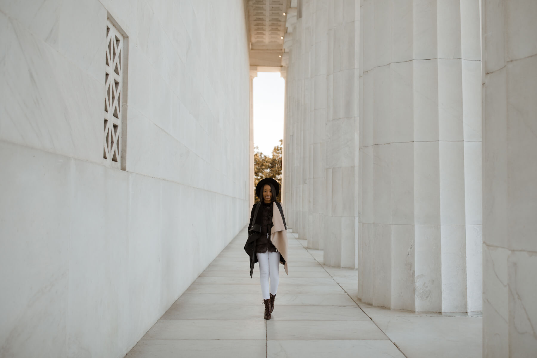 Woman walking at the Lincoln Memorial in Washington DC on a modern headshot photoshoot with Flytographer.