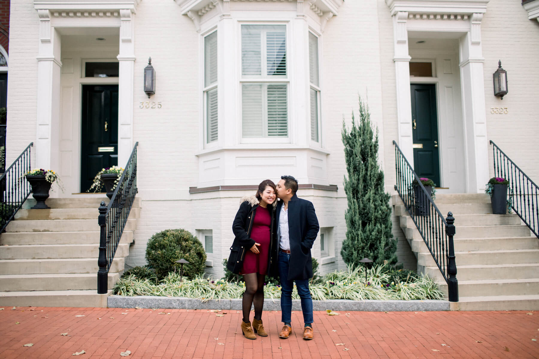 Couple pose in front of a building in Washington DC on a couple photoshoot with Flytographer.