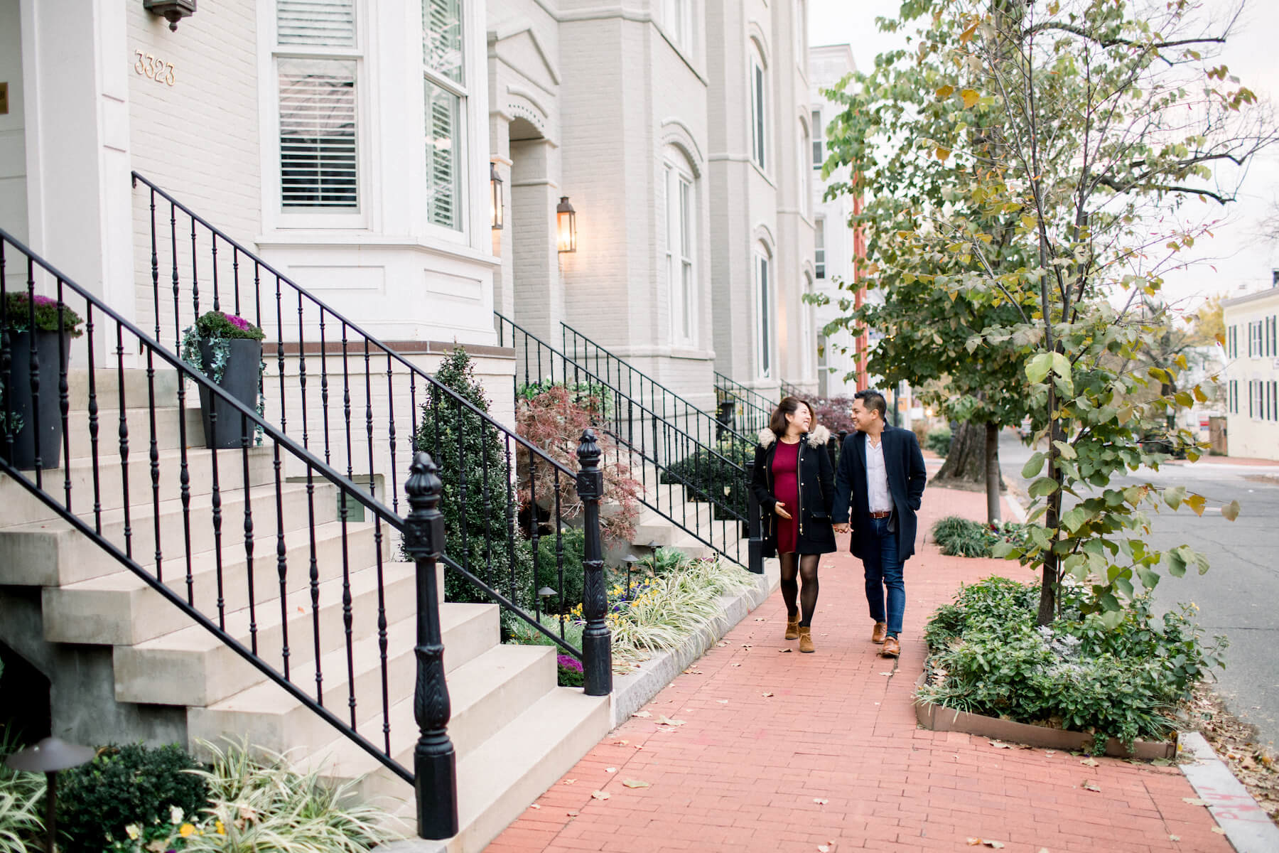 Couple walking on the sidewalk in Washington DC on a couple photoshoot with Flytographer.