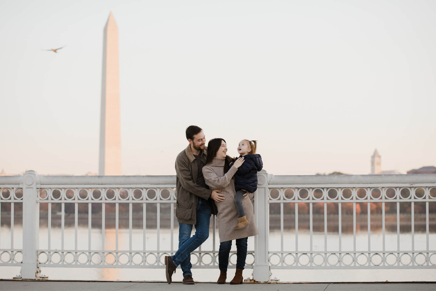 Family posing at the tidal basin in Washington DC on a family photoshoot with Flytographer.