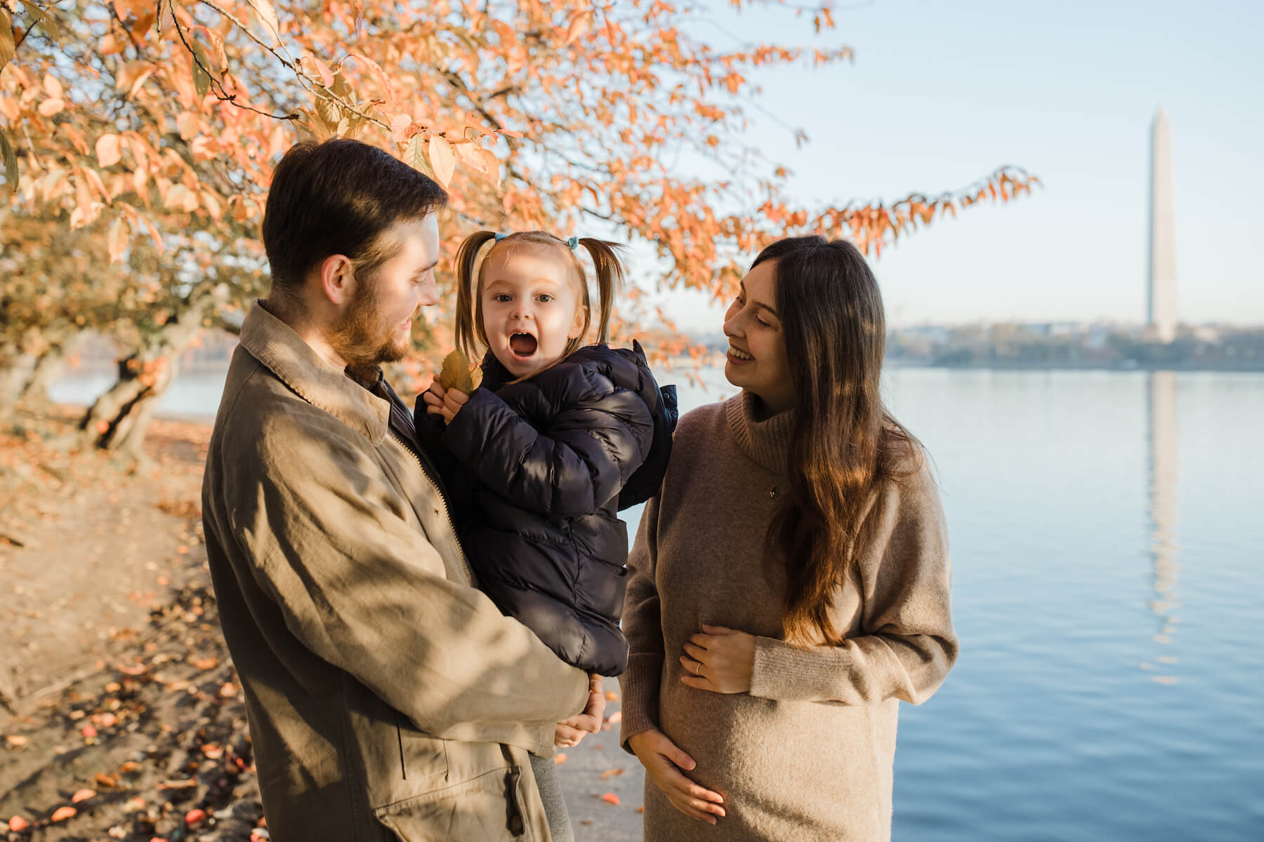 Family posing at the tidal basin in Washington DC on a family photoshoot with Flytographer.