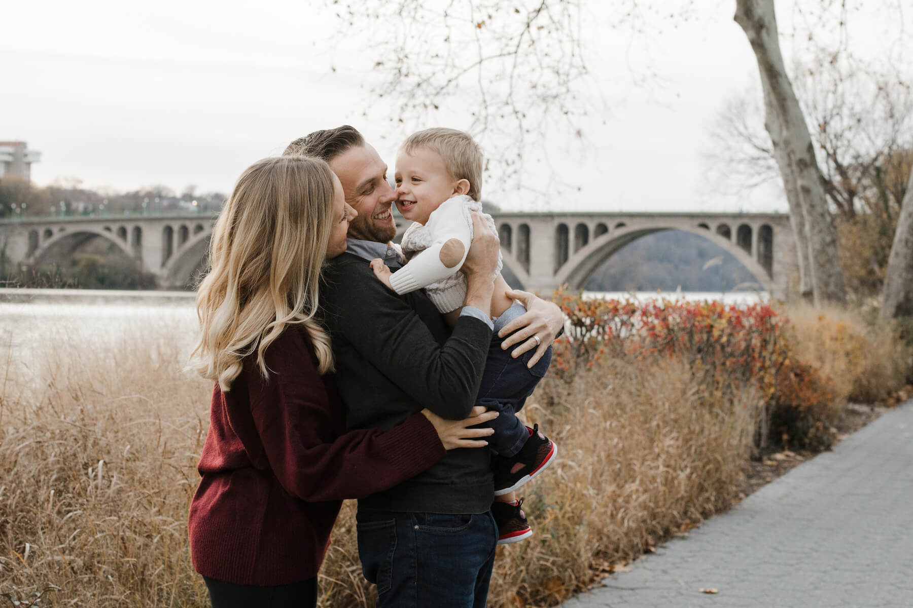Family posing at the canal Washington DC on a family photoshoot with Flytographer.