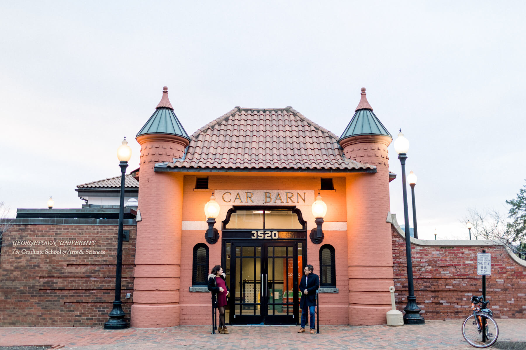 Couple pose in front of a building in Washington DC on a couple photoshoot with Flytographer.