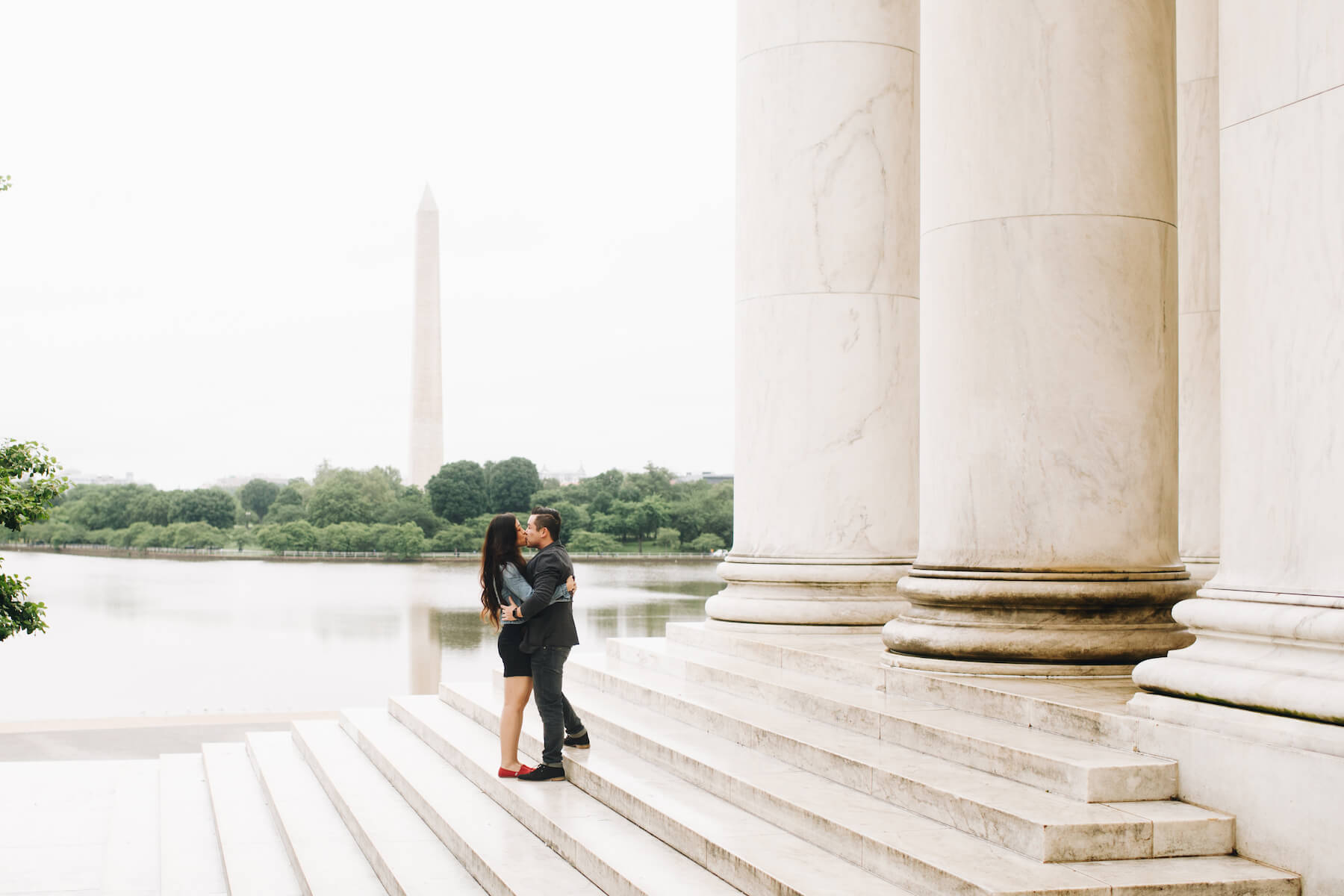 Couple on the steps of the Lincoln Memorial with the Washington Monument in the background in Washington DC on a couple photoshoot with Flytographer.
