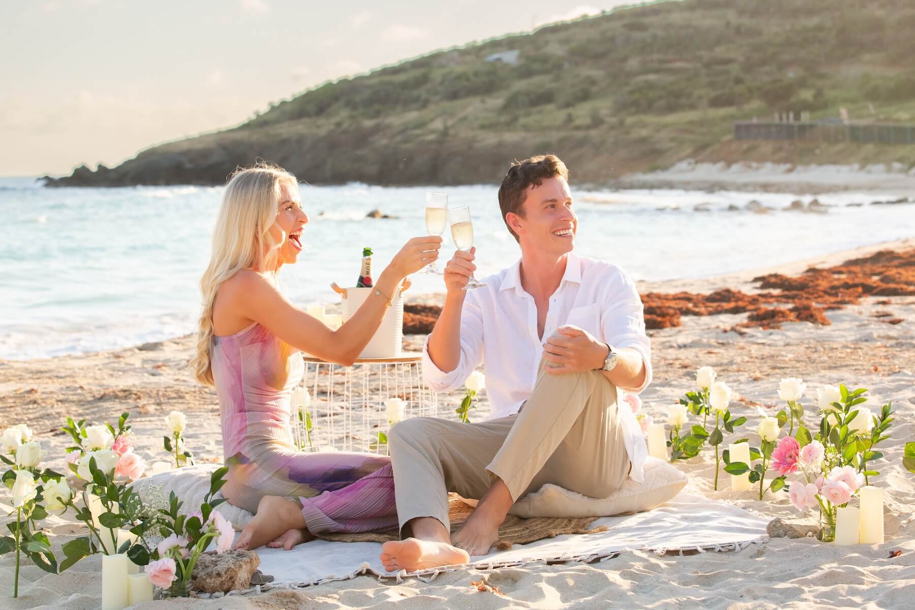 Woman wearing a red dress is being proposed to on a doc in Mauritius