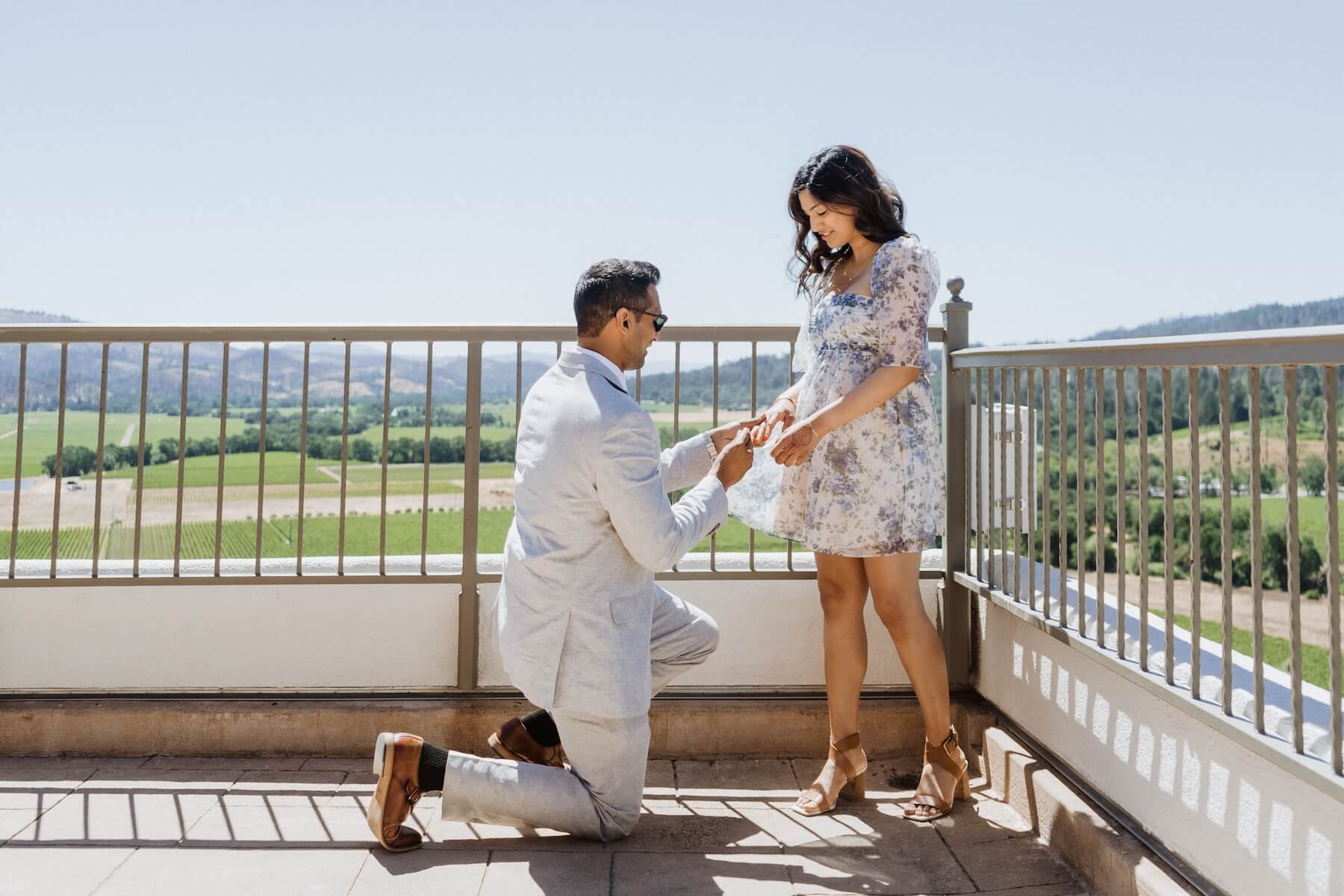Woman wearing a red dress is being proposed to on a doc in Mauritius