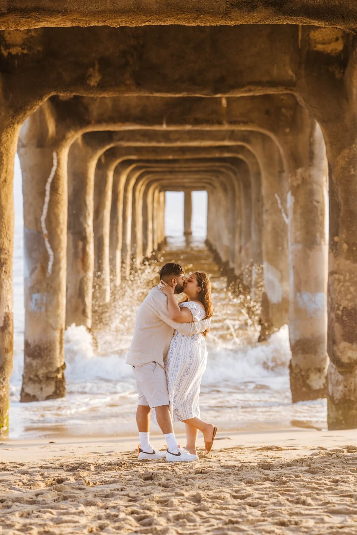 Woman wearing a red dress is being proposed to on a doc in Mauritius