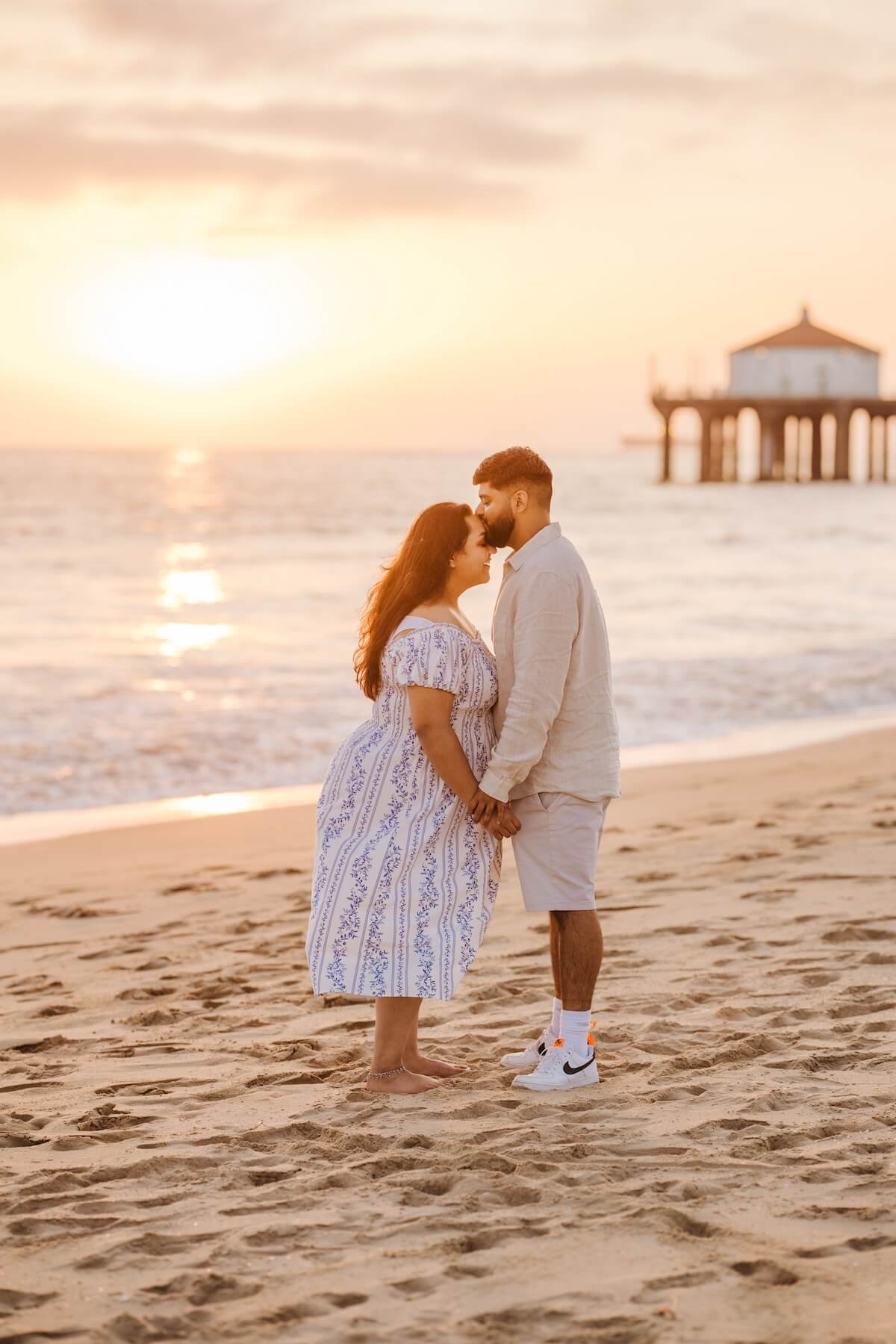 Woman wearing a red dress is being proposed to on a doc in Mauritius