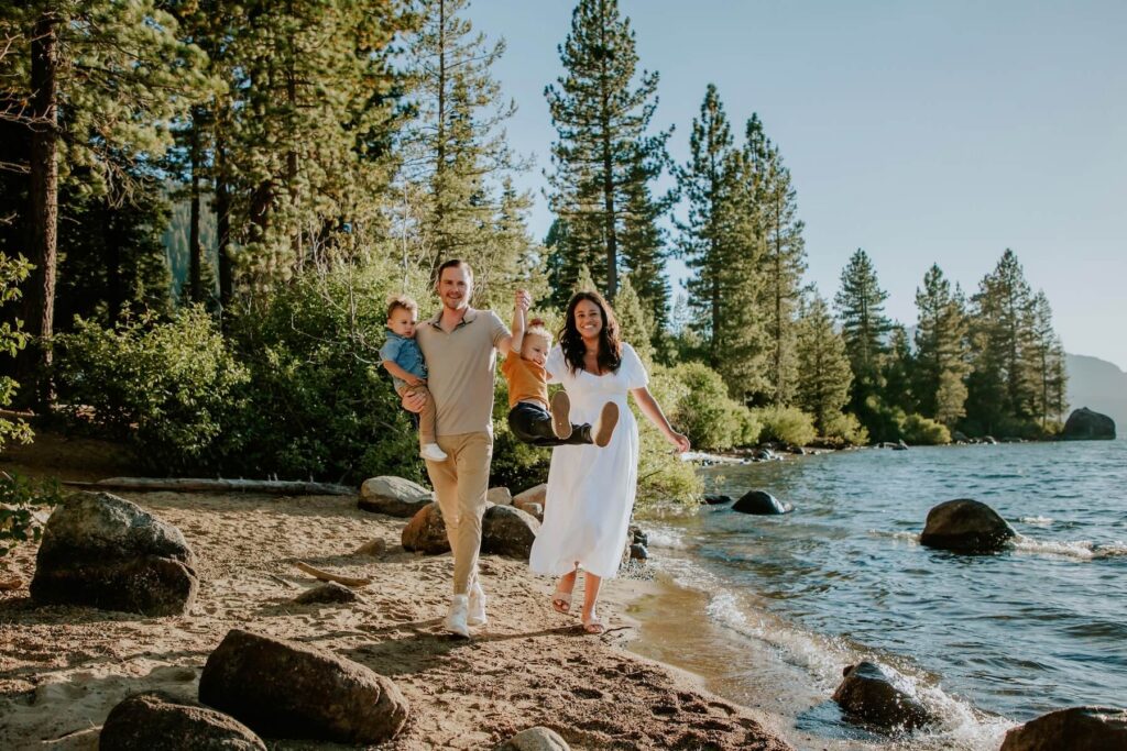 Family playing on the beach in Lake Tahoe on a family photoshoot with Flytographer.