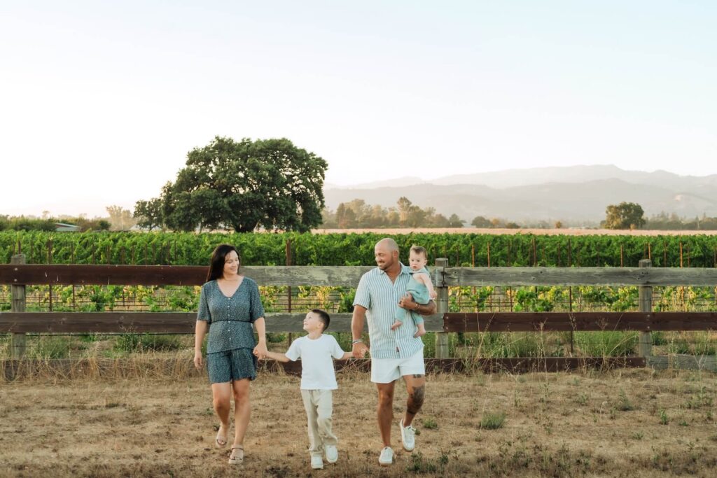 Family walking along a vineyard in Napa Valley on a family photoshoot with Flytographer.