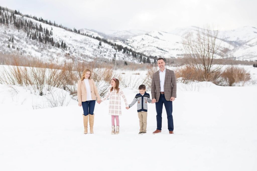 A family walking in the snow in Park City on a family photoshoot with Flytographer.